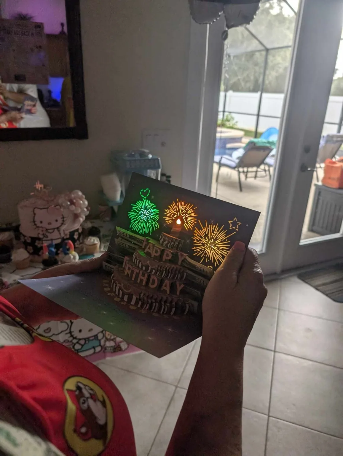 Lisa holding an illuminated pop-up birthday card