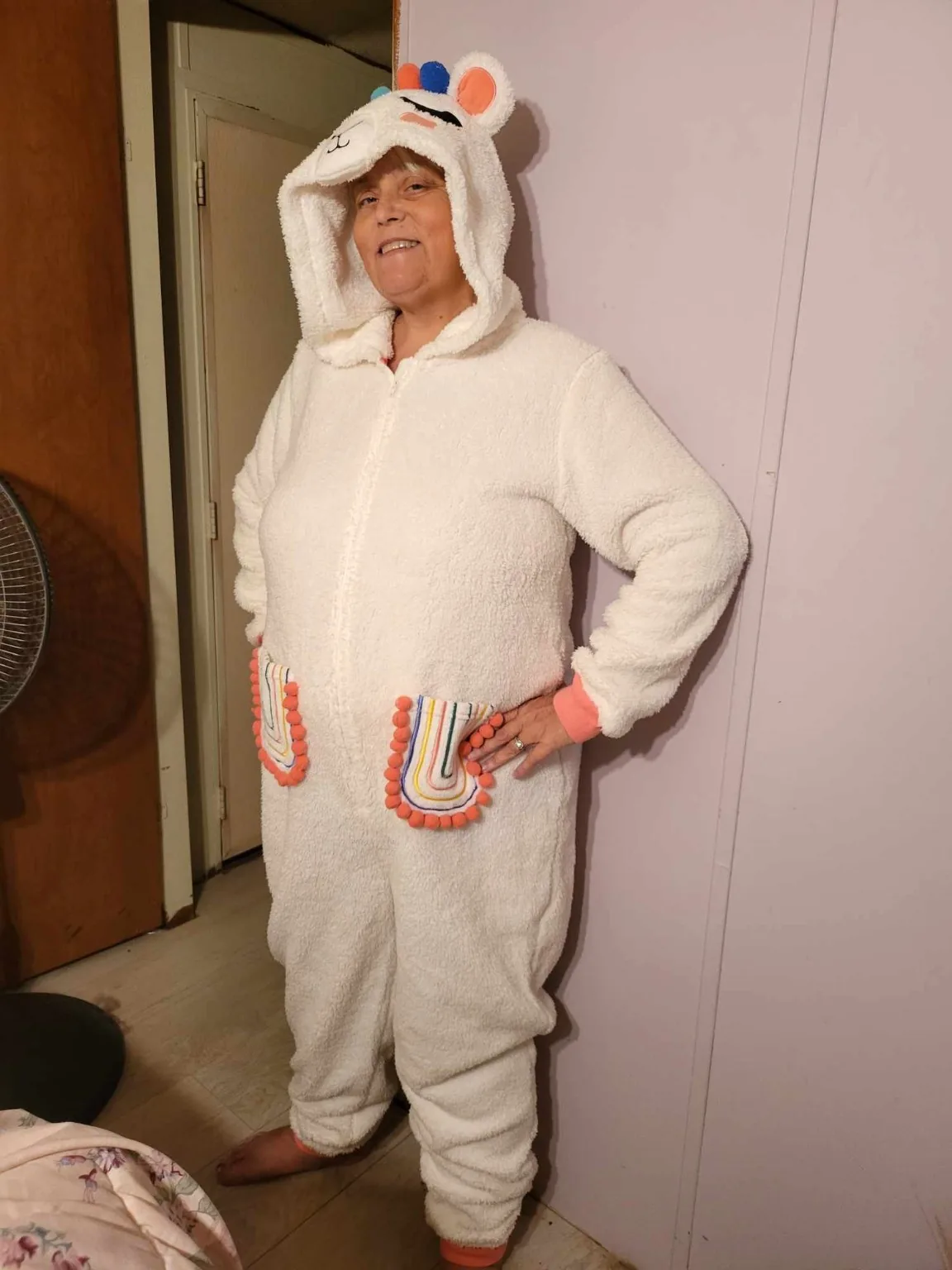 Lisa smiling in a playful white animal onesie
