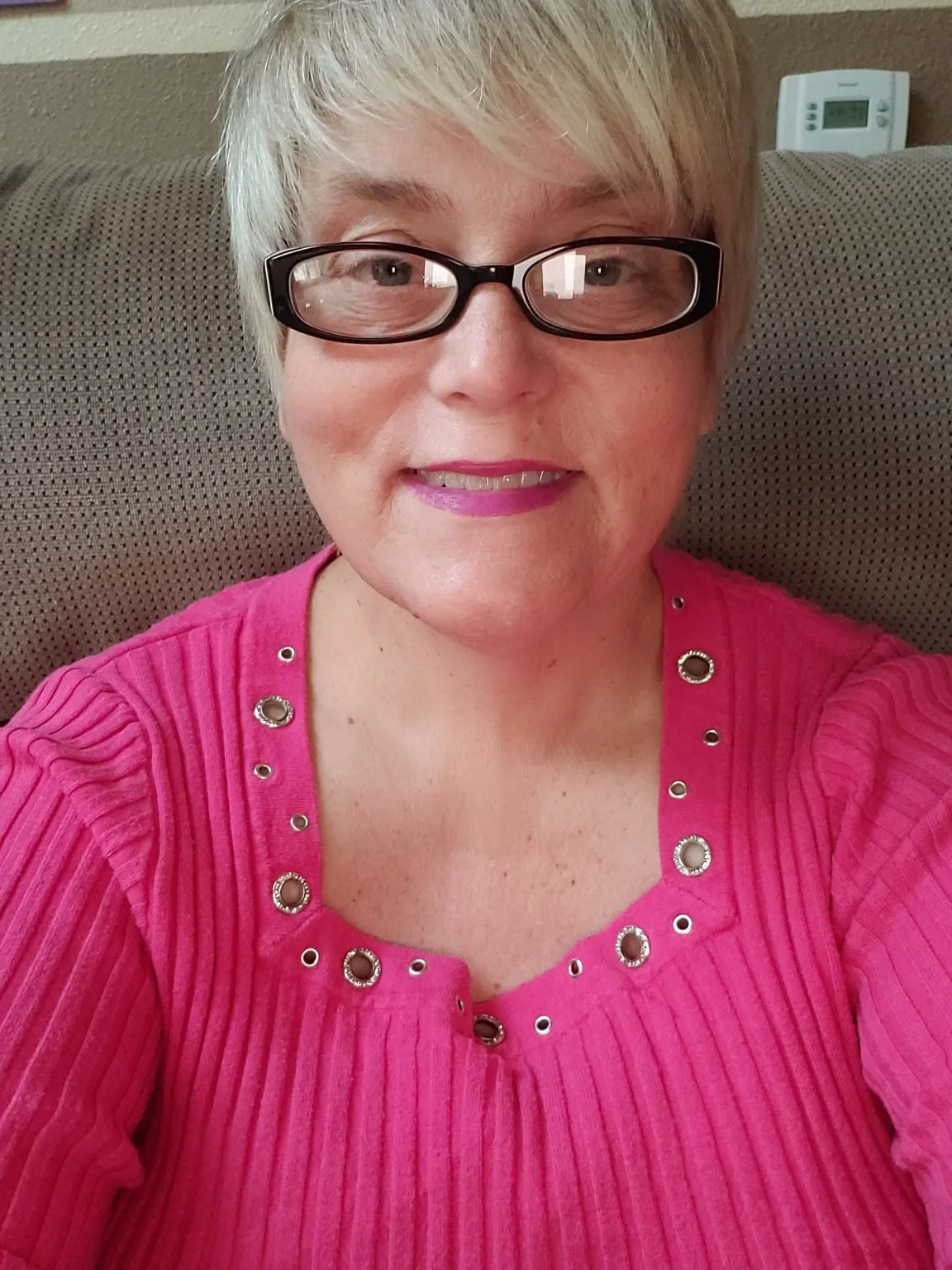 Portrait of Lisa wearing a bright pink top